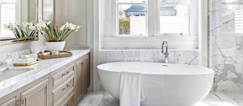 Modern bathroom with white subway tile walls, floating vanity with undermount sink, large mirror, and contemporary fixtures